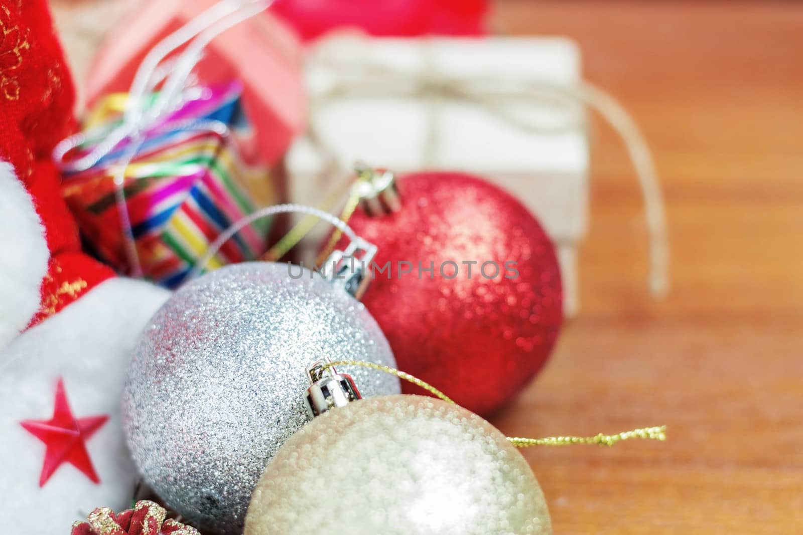 Balls and gift boxes on wooden board.