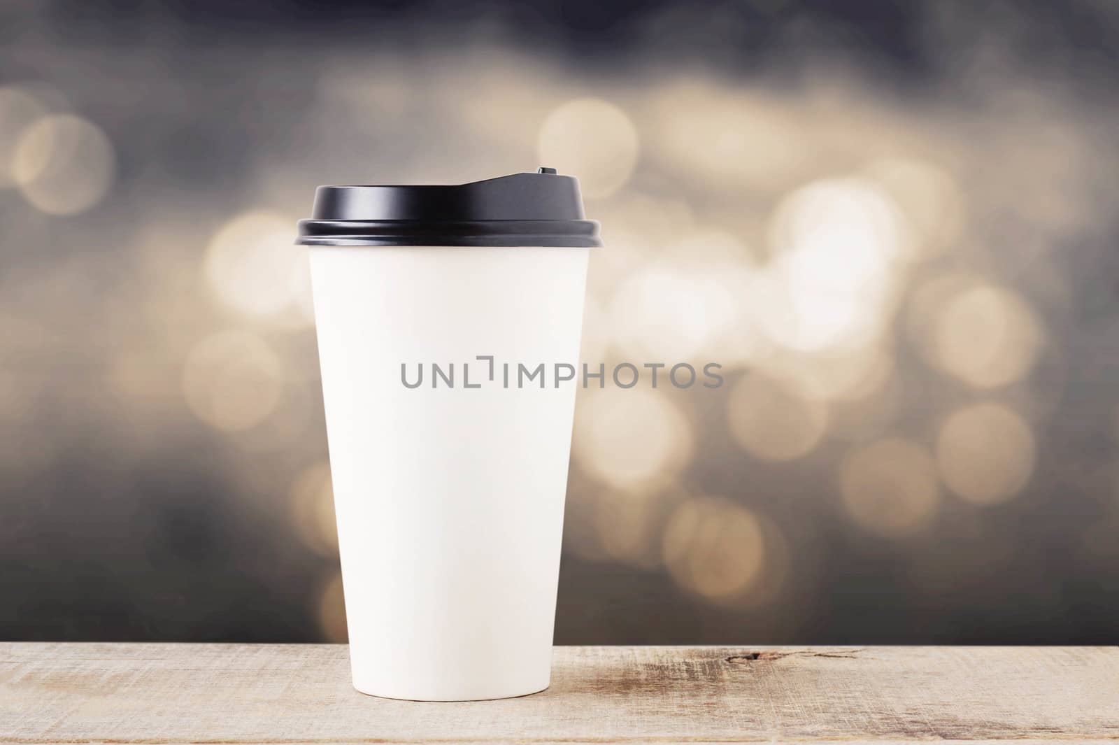 Coffee cup paper on wooden with bokeh background.