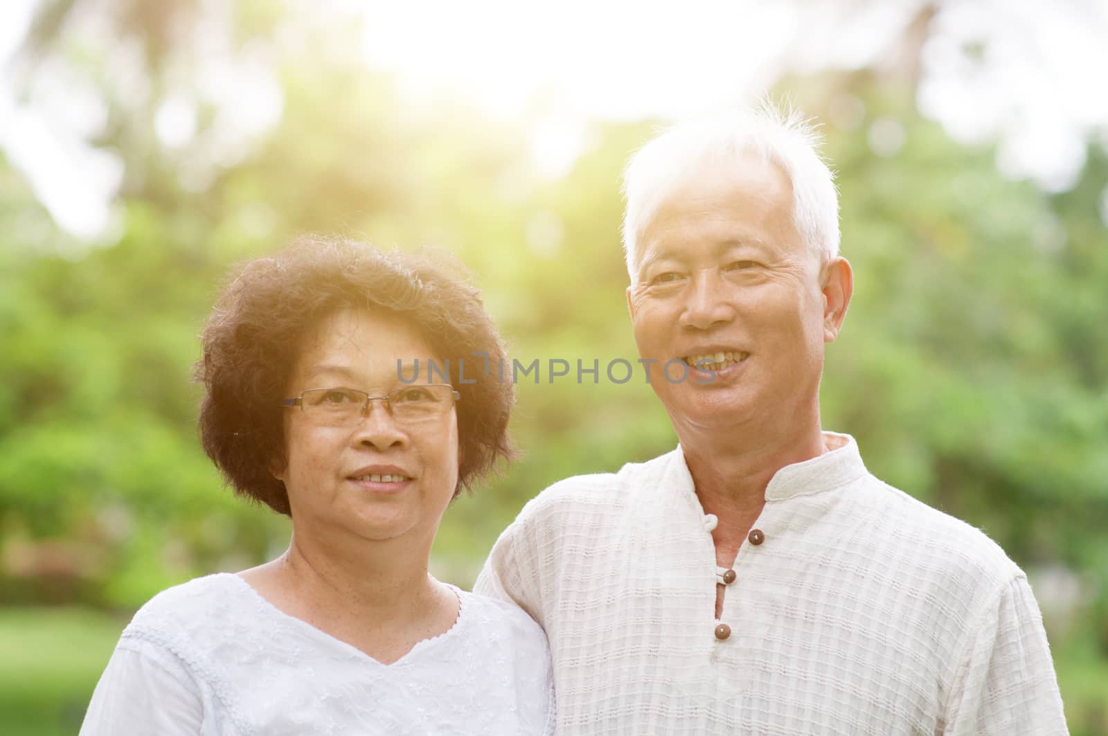 Happy elderly Asian couple smiling. by szefei