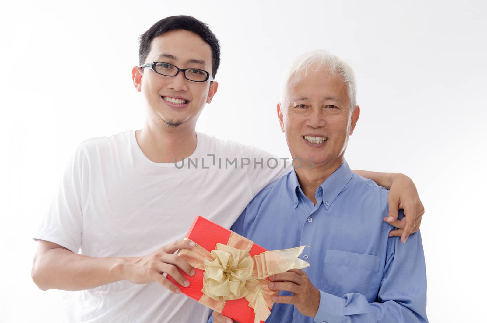 Asian old father and son hand holding a gift box and smiling,  standing isolated on white background.