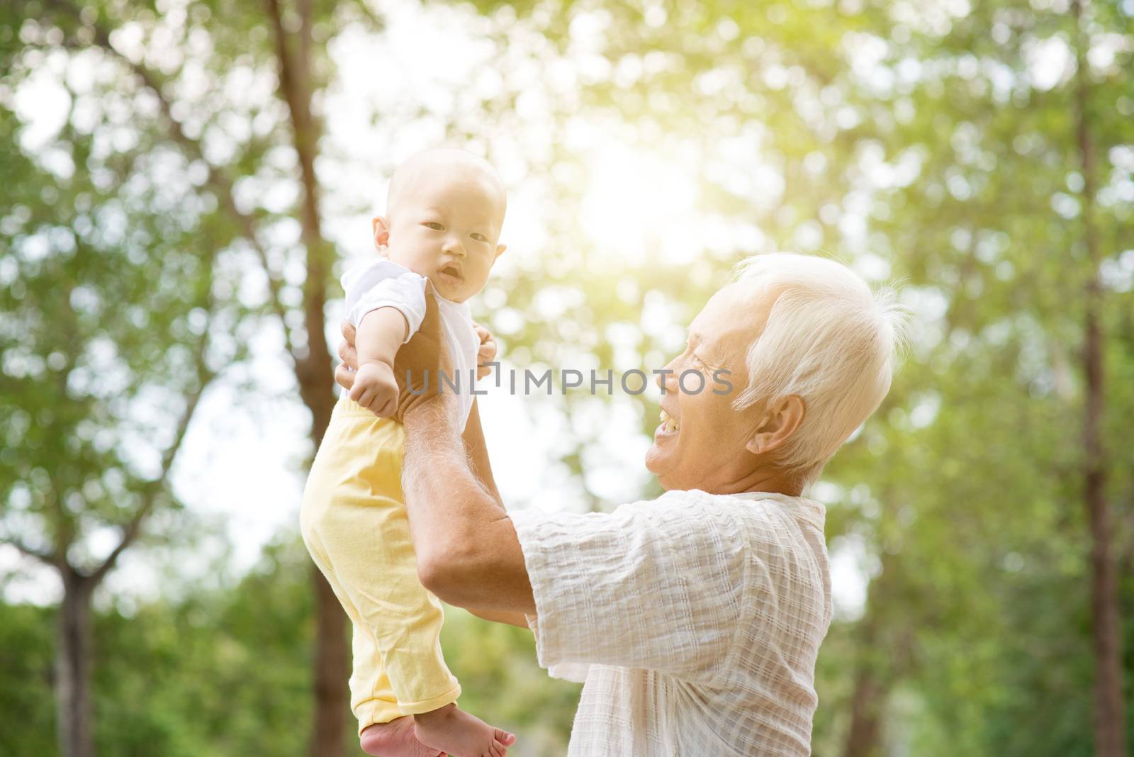 Grandfather with baby grandchild, Asian family, life insurance concept.