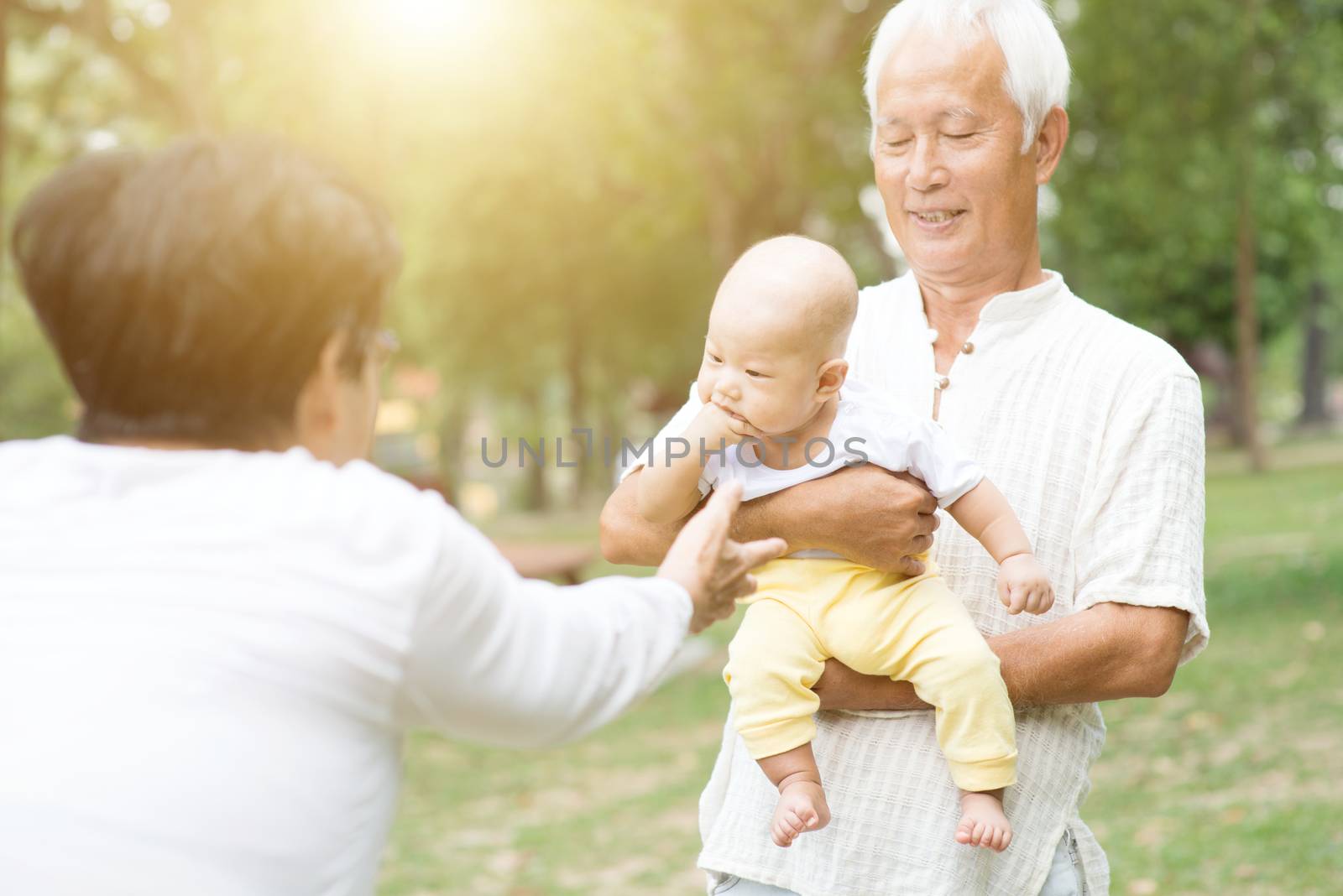 Senior couple with baby grandchild, Asian grandparents family, life insurance concept.