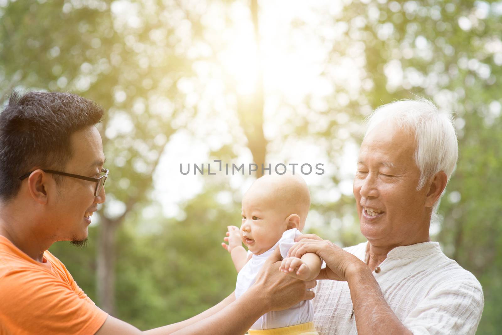 Multi generations family, baby grandchild, father and grandfather having fun outdoors. Life insurance concept.