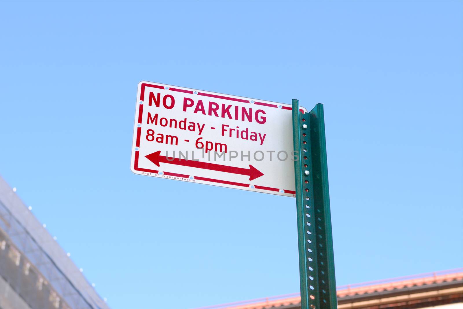 NO PARKING street sign, applicable daytime on week days, stands against a blue sky
