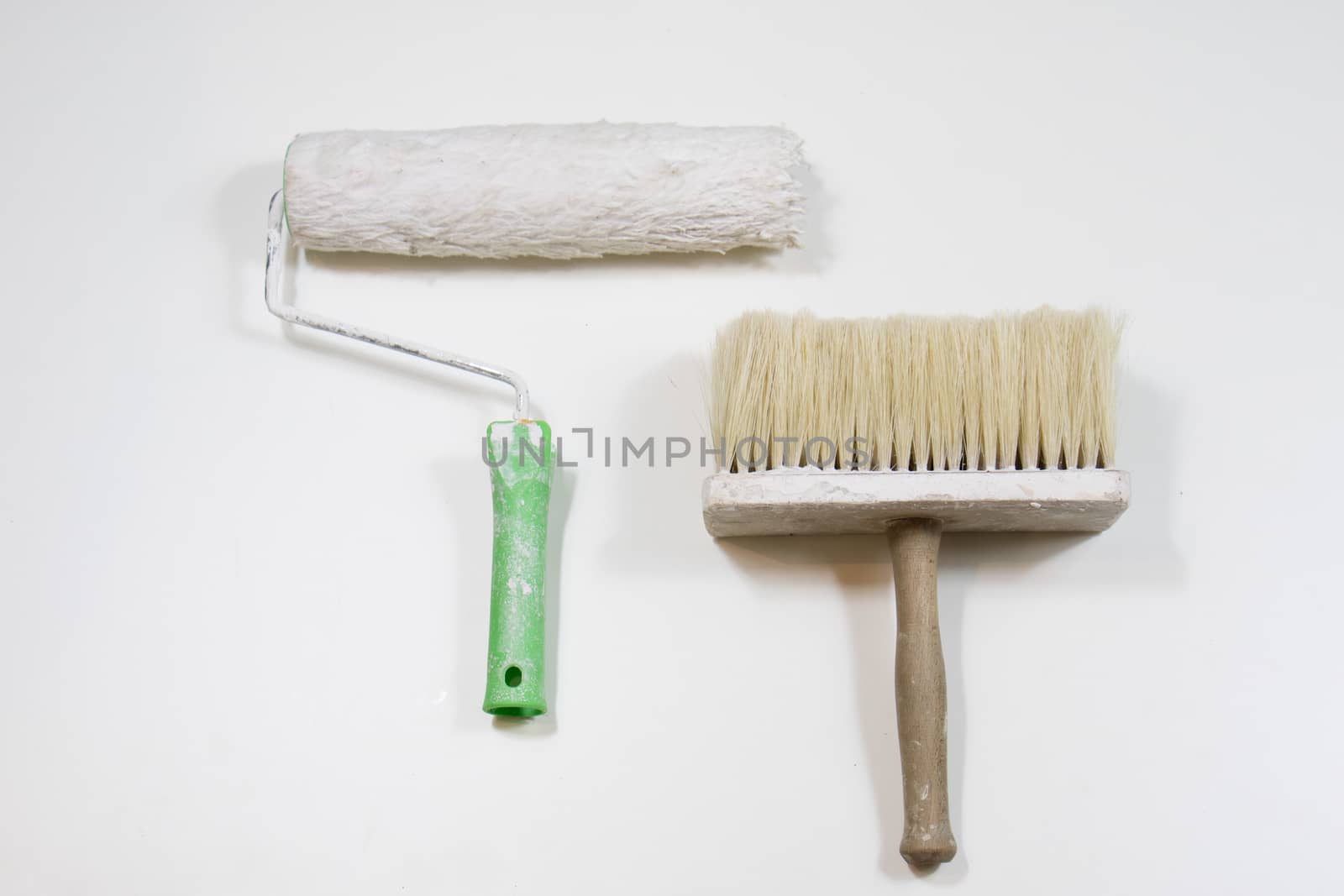 Roller and paint brush on a white background. Old painting tools