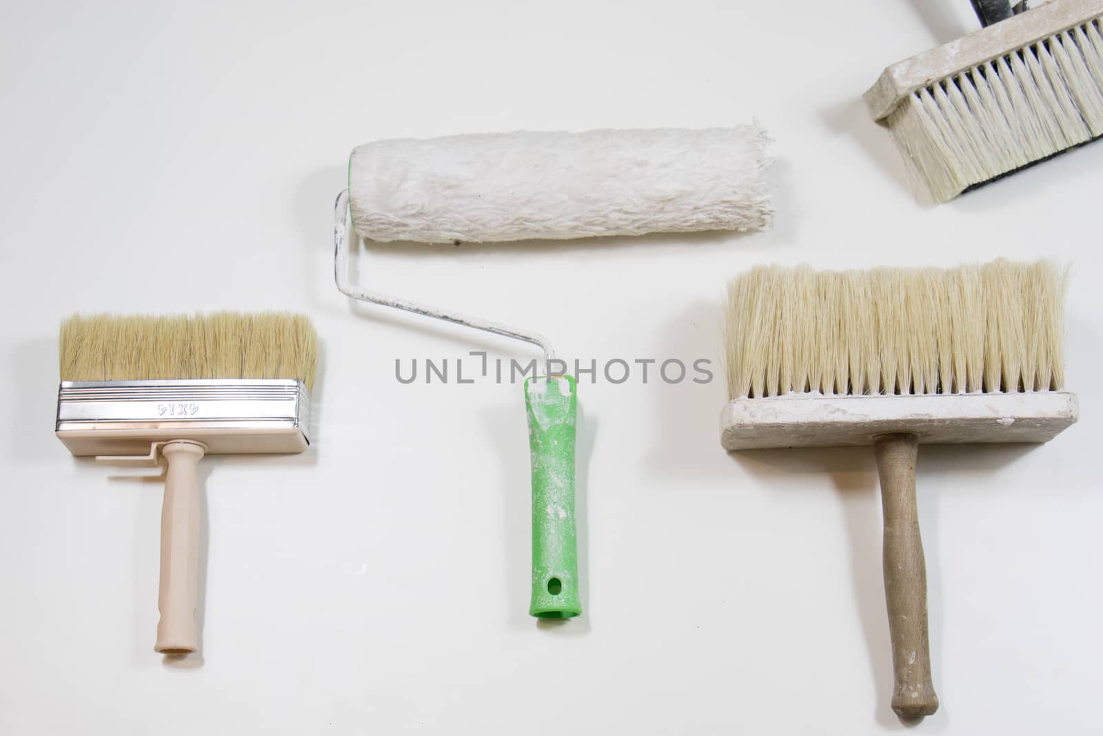 Roller and paint brush on a white background. Old painting tools