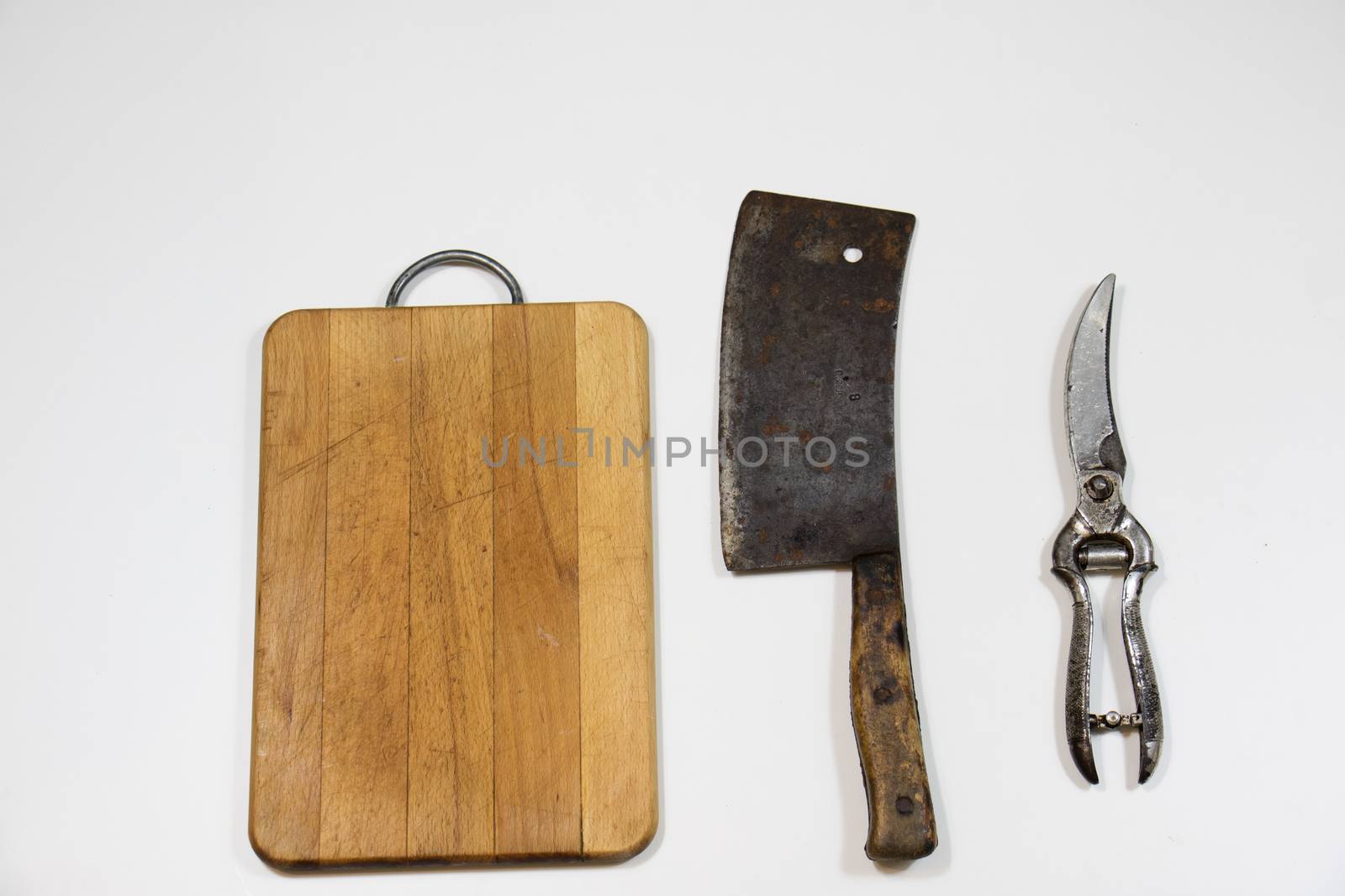 Old chopper and board, tools for butcher, white background.