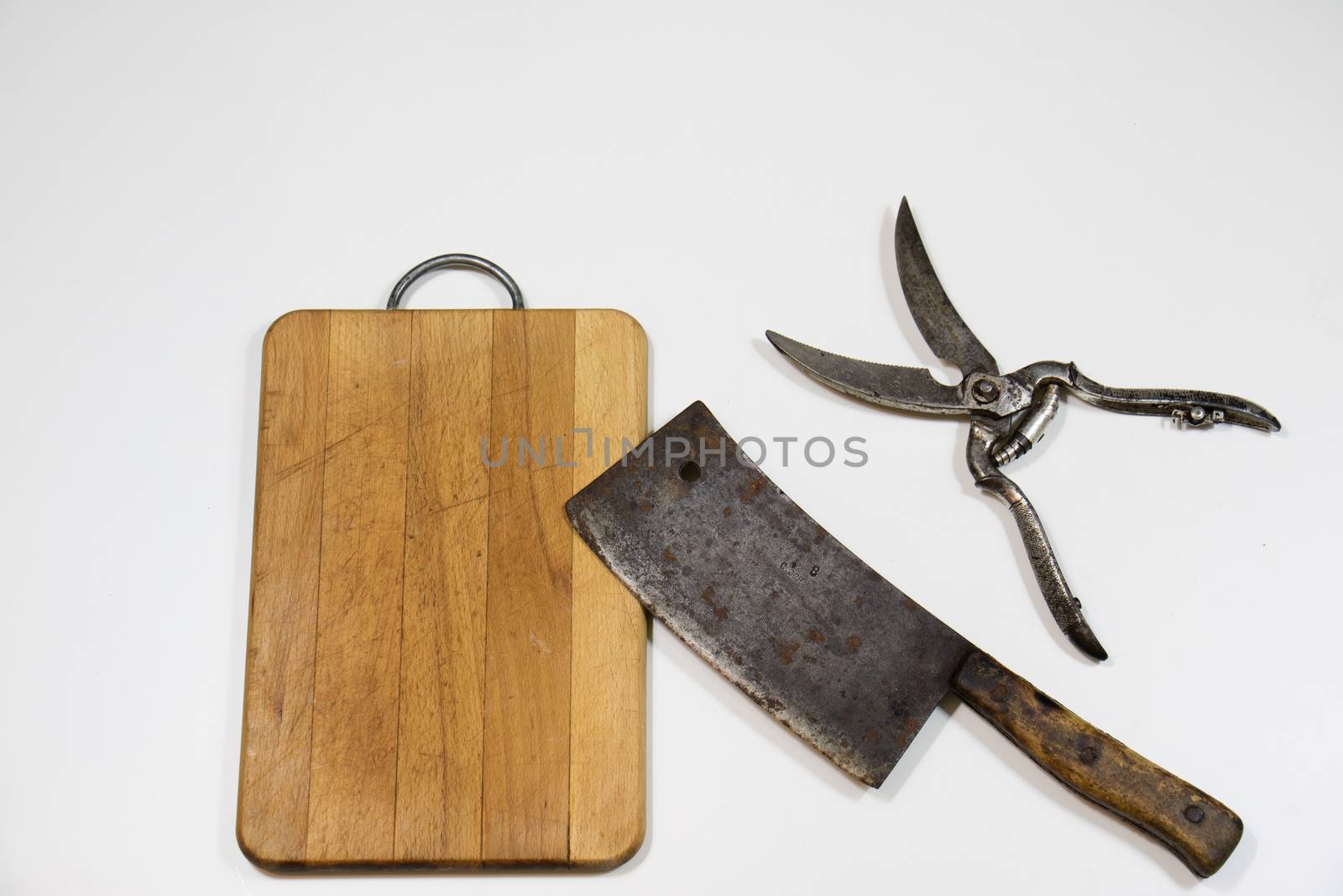 Old chopper and board, tools for butcher, white background.