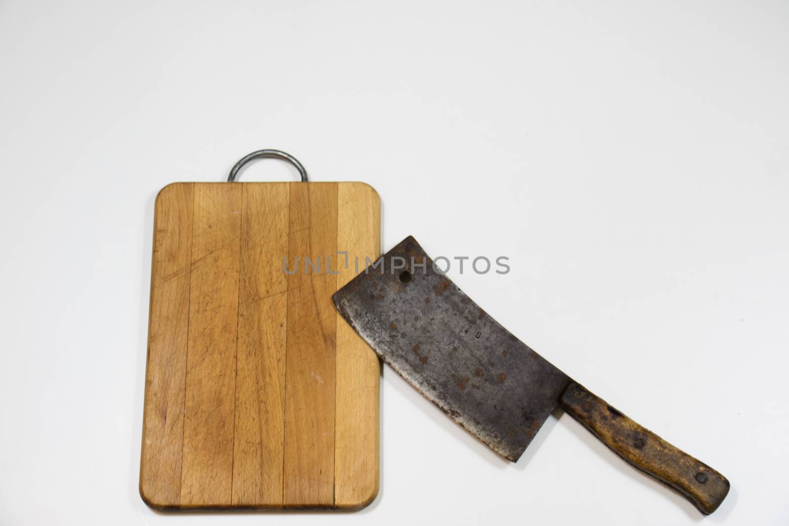 Old chopper and board, tools for butcher, white background.