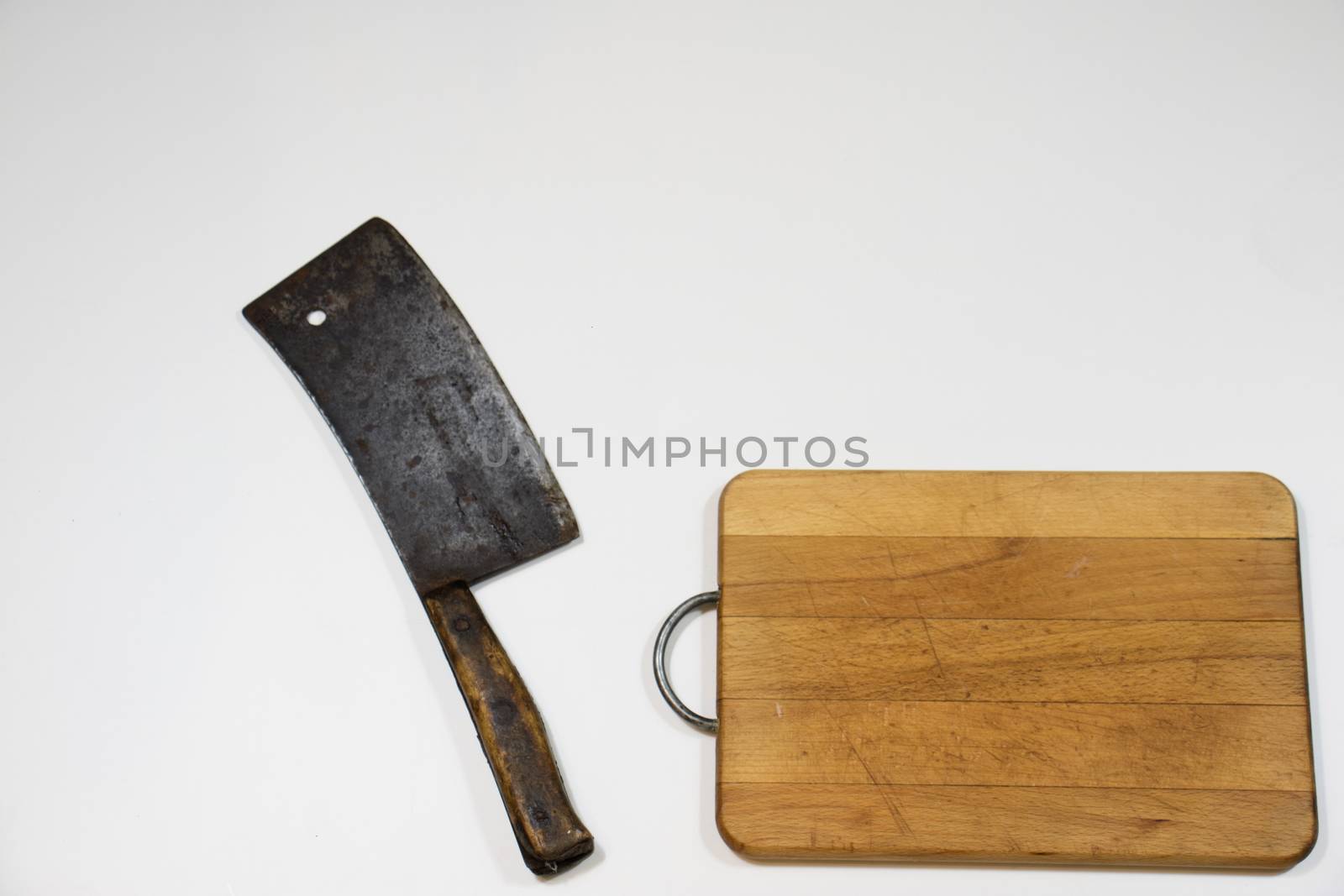 Old chopper and board, tools for butcher, white background.