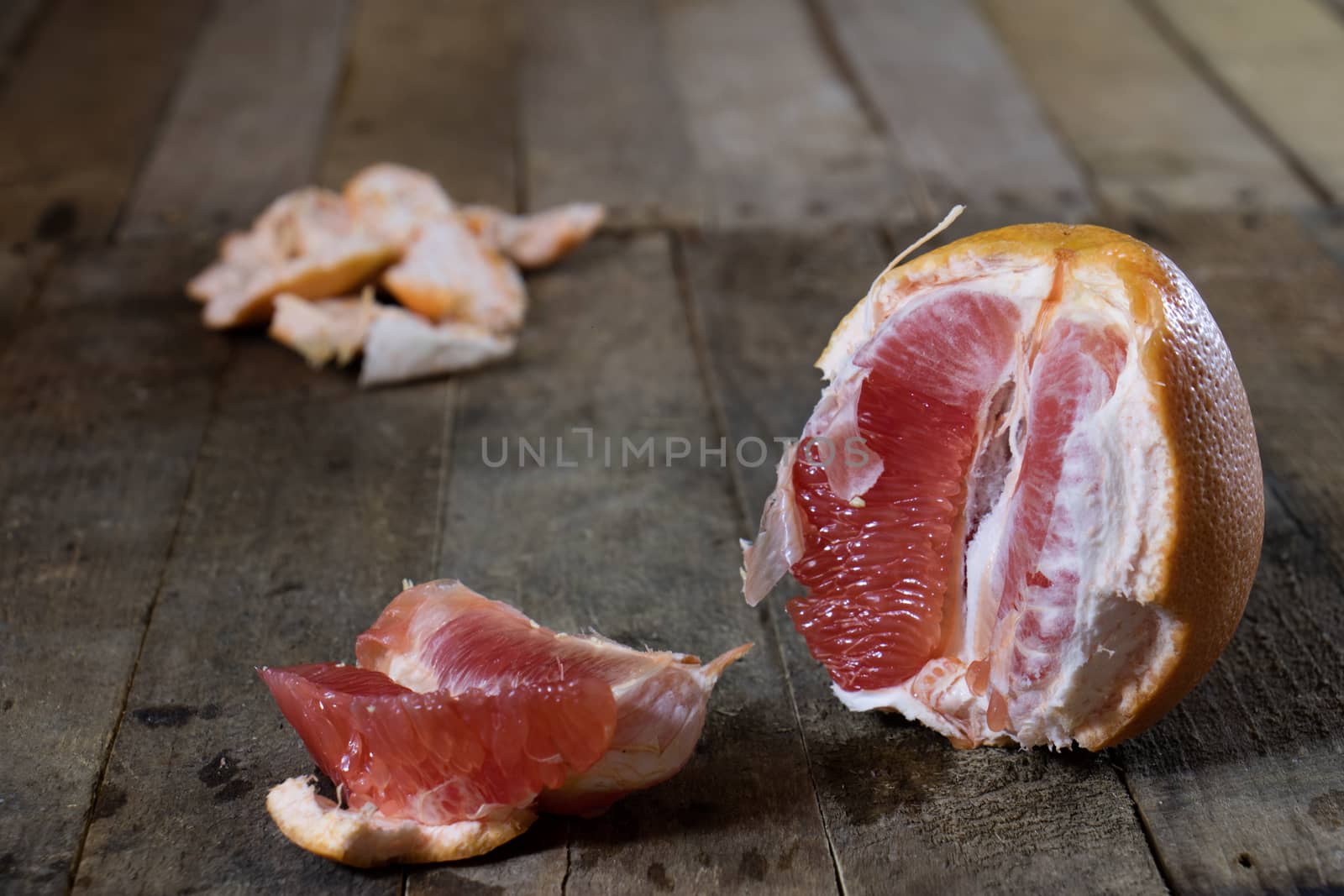 Picked grapefruit on a wooden table, juices and peaches, old kitchen