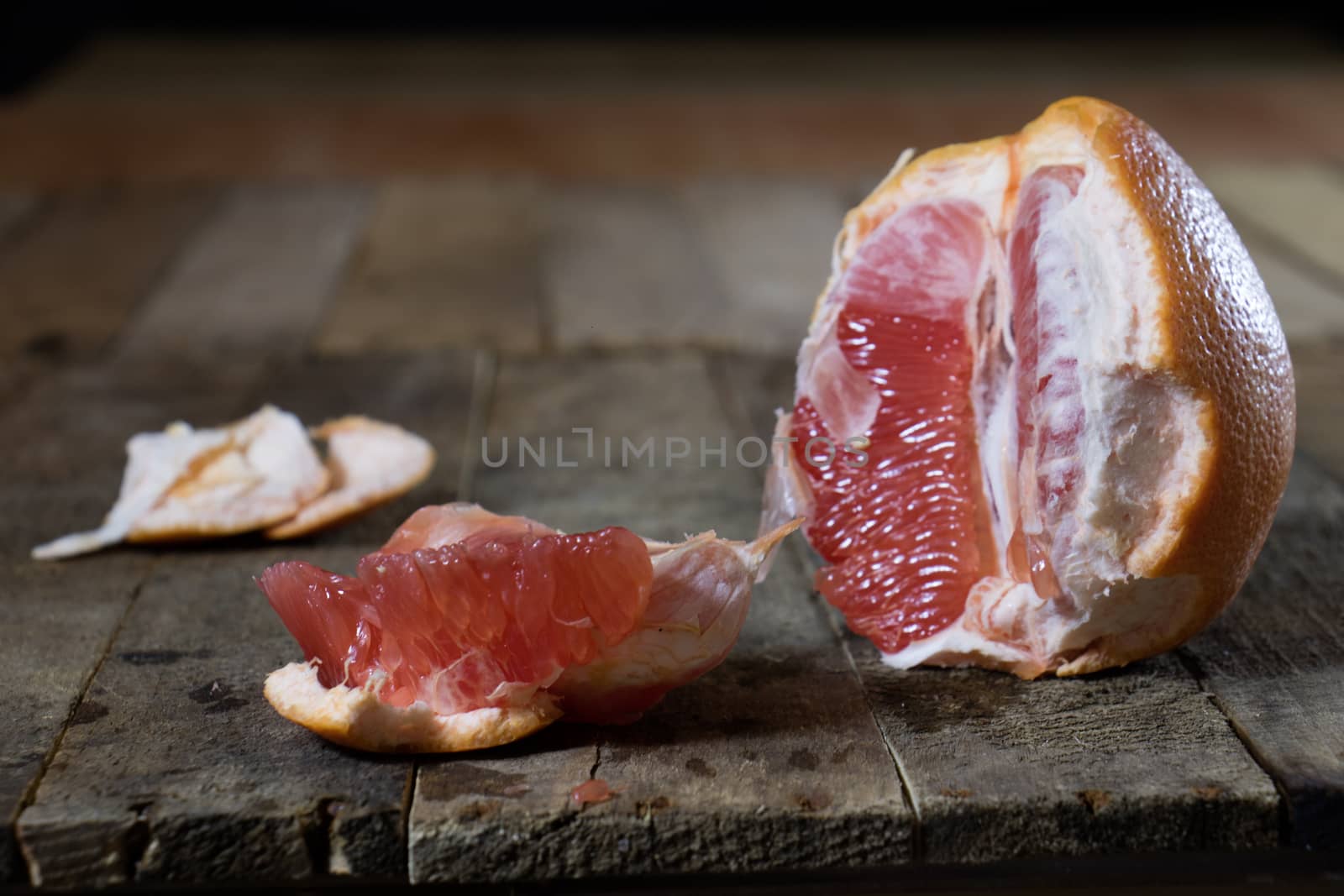 Picked grapefruit on a wooden table, juices and peaches, old kitchen