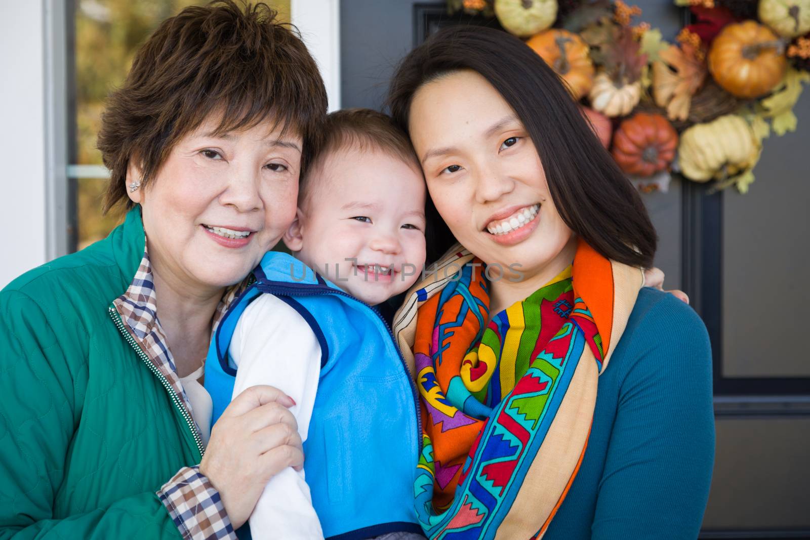Happy Chinese Senior Adult Grandmother with Her Daughter and Gra by Feverpitched