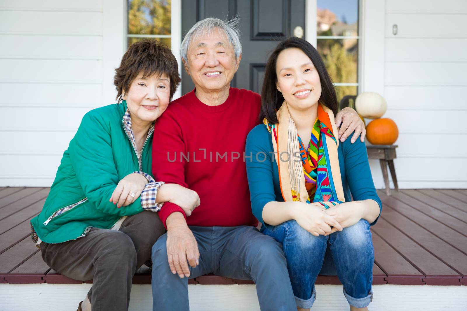 Happy Chinese Senior Adult Mother and Father with Young Adult Da by Feverpitched