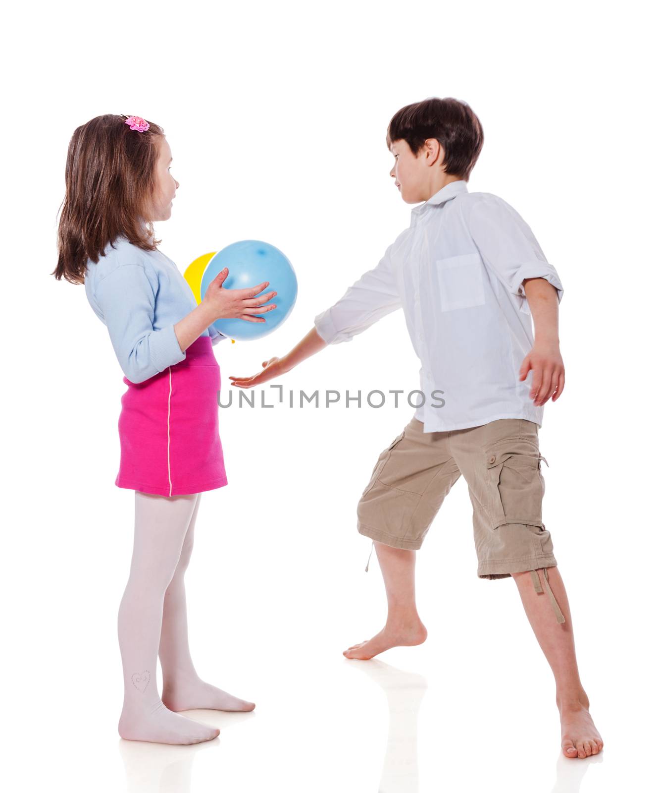 Brother and sister playing with balloons standing isolated on white