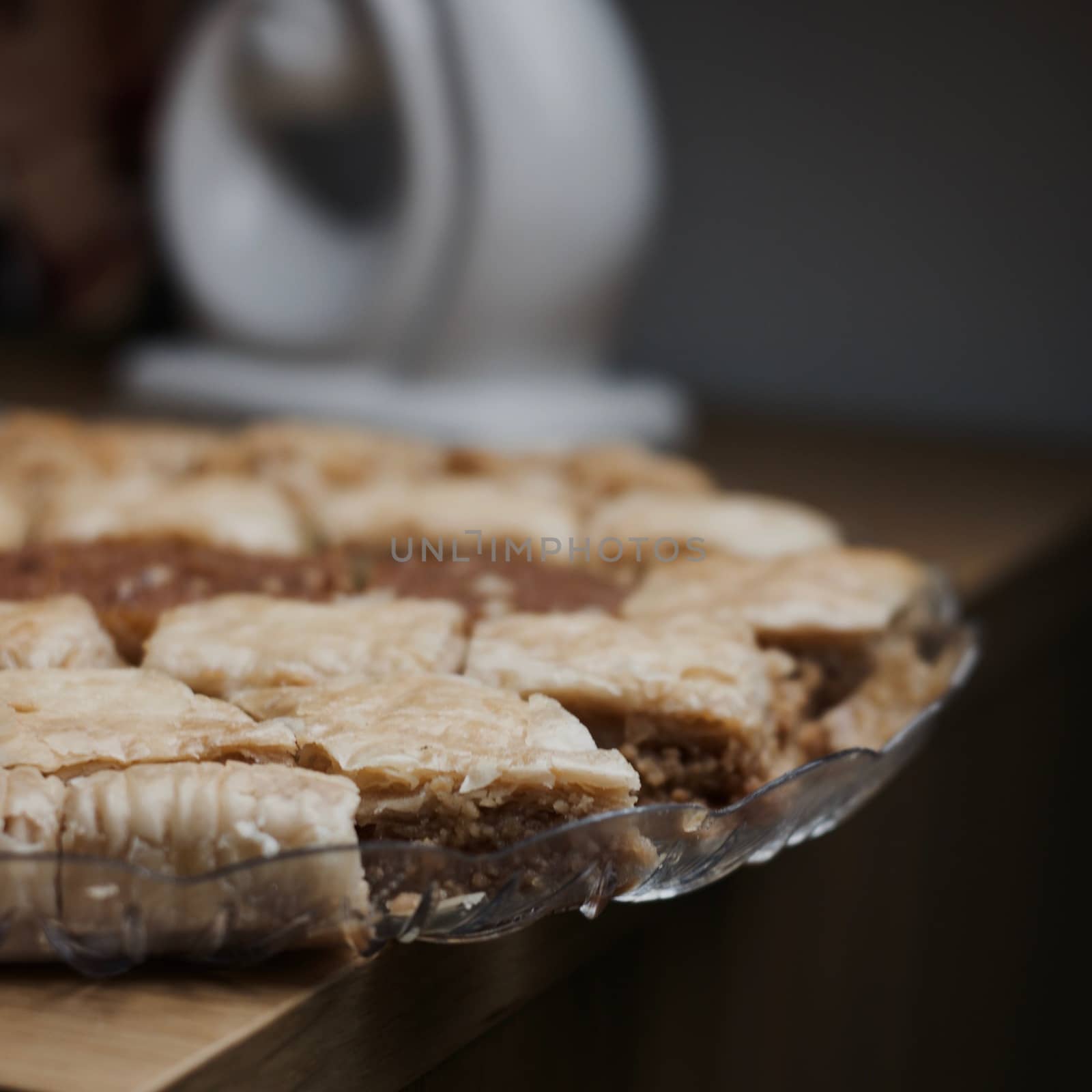 Tasty and sweet Turkish cookies on a transparent plate in room. Food concept.