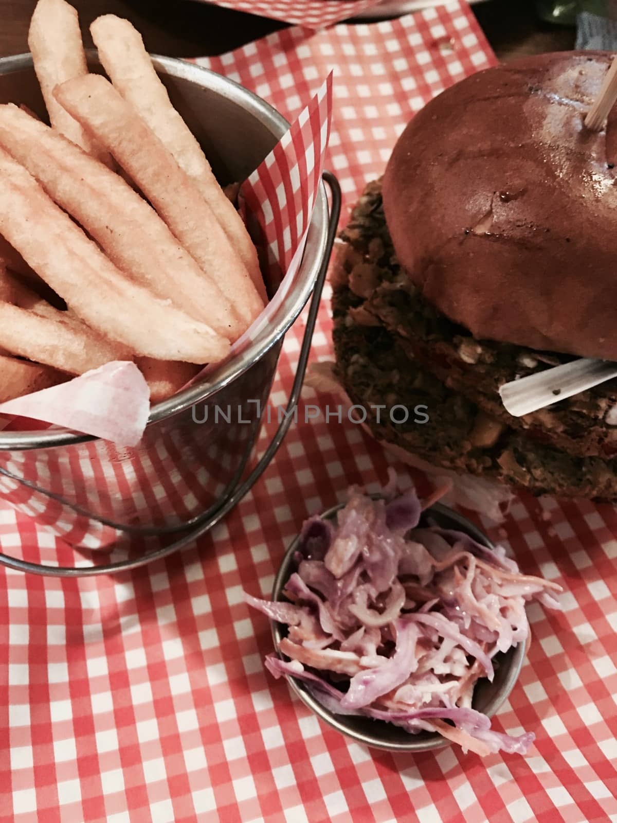 Big, fresh and delicious vegetable burger in restaurant on the white plate.
