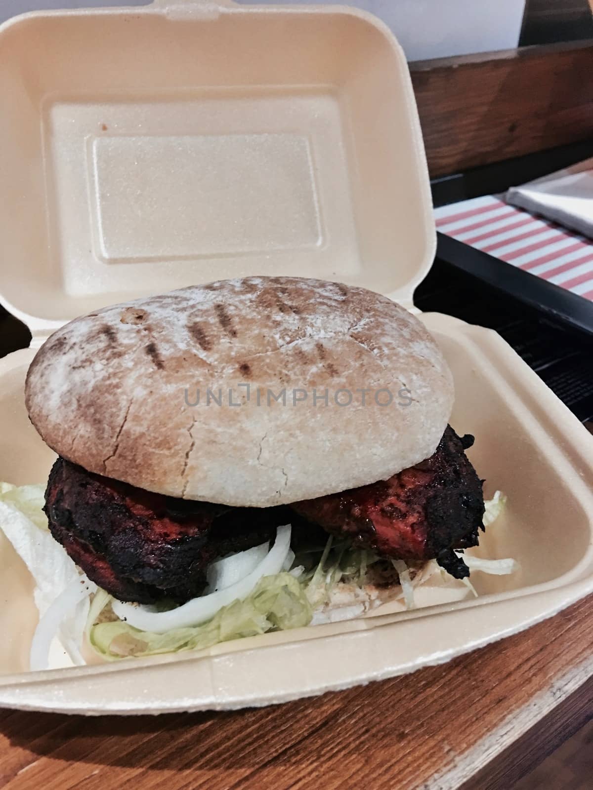 Delicious and fresh red meat chicken burger in a box. Fast food concept.
