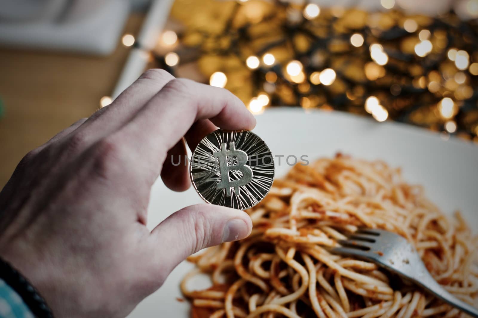 Digital currency physical metal bitcoin coin. Restaurant pasta concept.