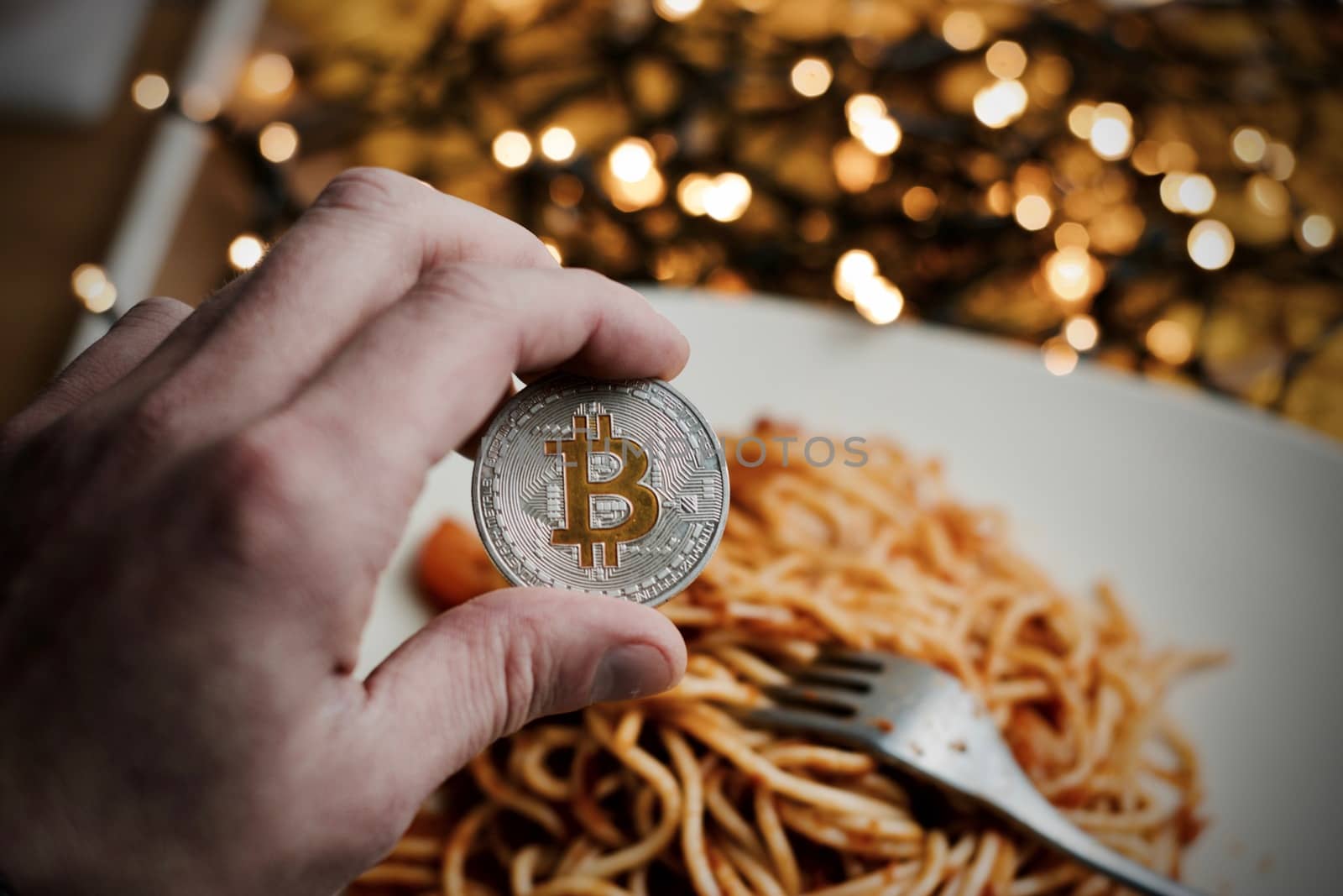 Digital currency physical metal bitcoin coin. Restaurant pasta concept.