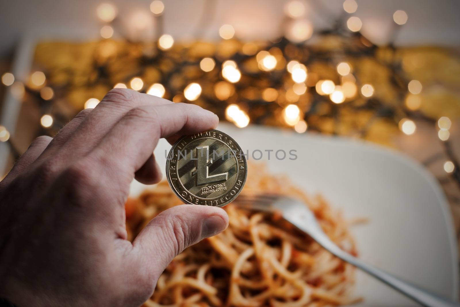 Digital currency physical metal gold litecoin coin. Italian food concept.