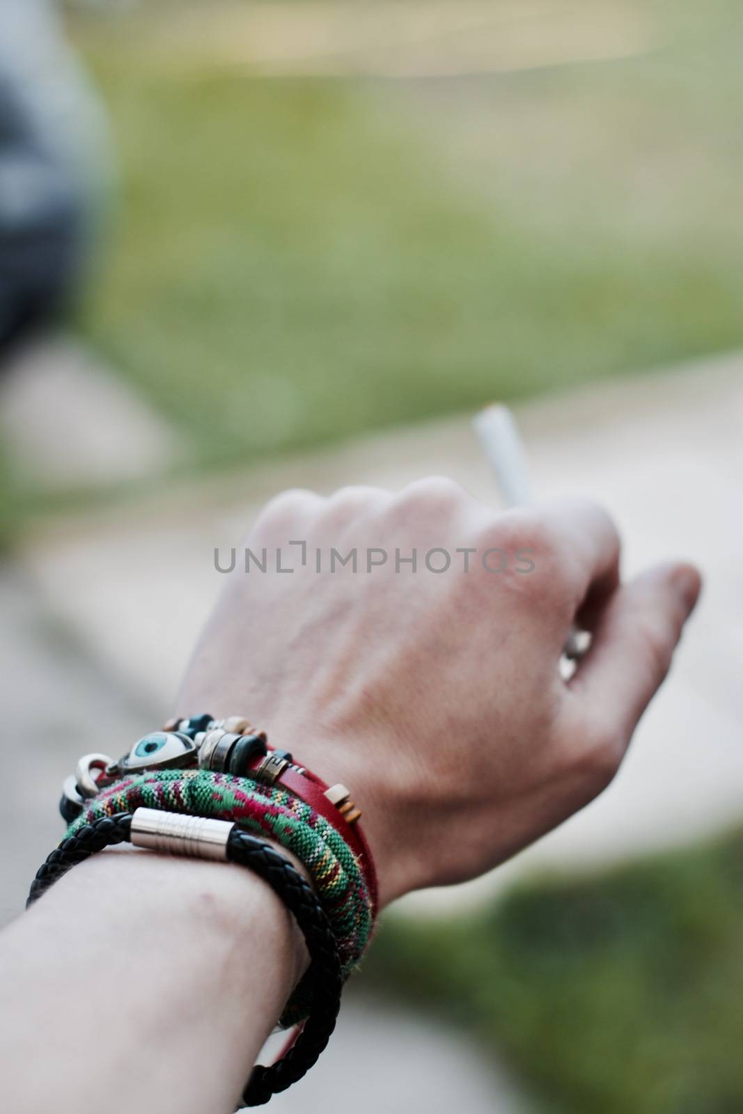 Small spliff in man hand. Marijuana smoking concept.