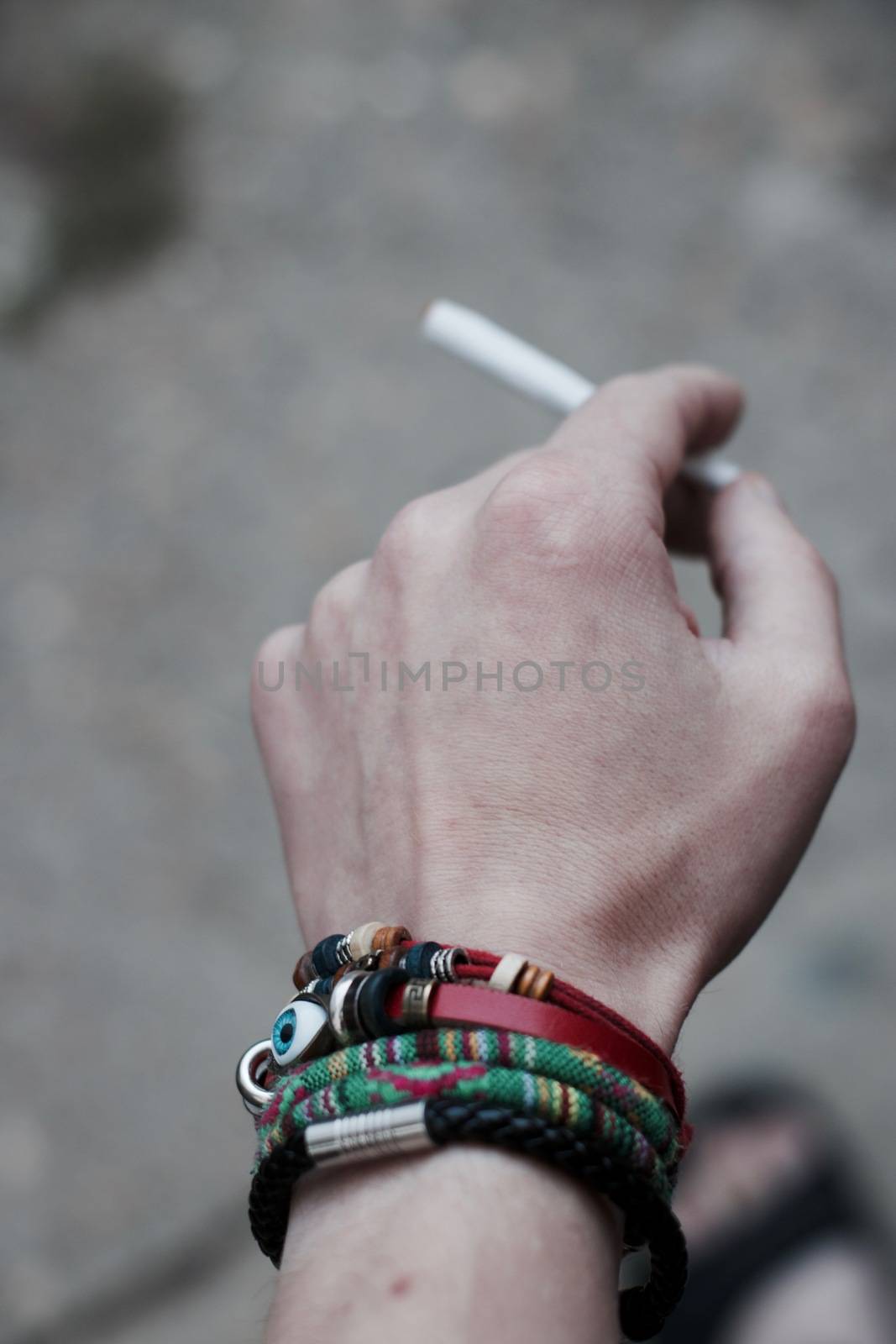 Small spliff in man hand. Marijuana smoking concept.