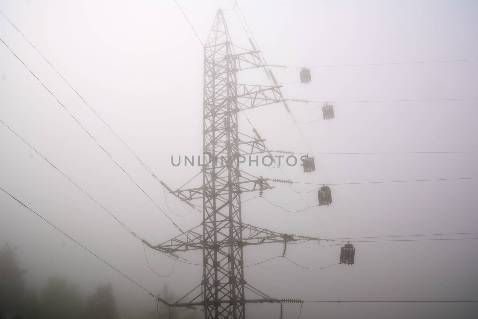 Electric high voltage power post, abstract view in morning haze