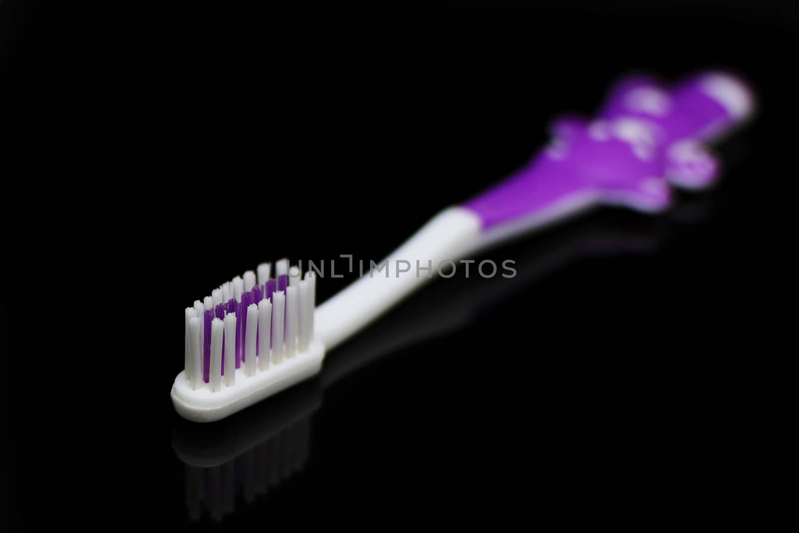 toothbrush on a black background by esal78