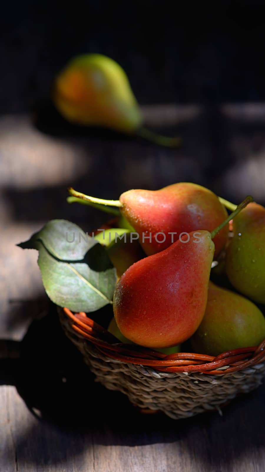 Pears in a basket on wooden table