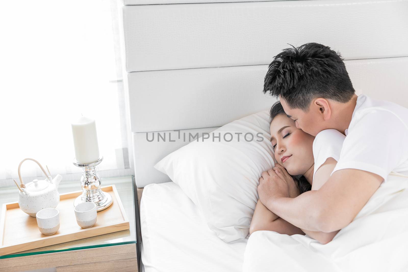 Young loving couple in the bed. Modern lifestyle concept