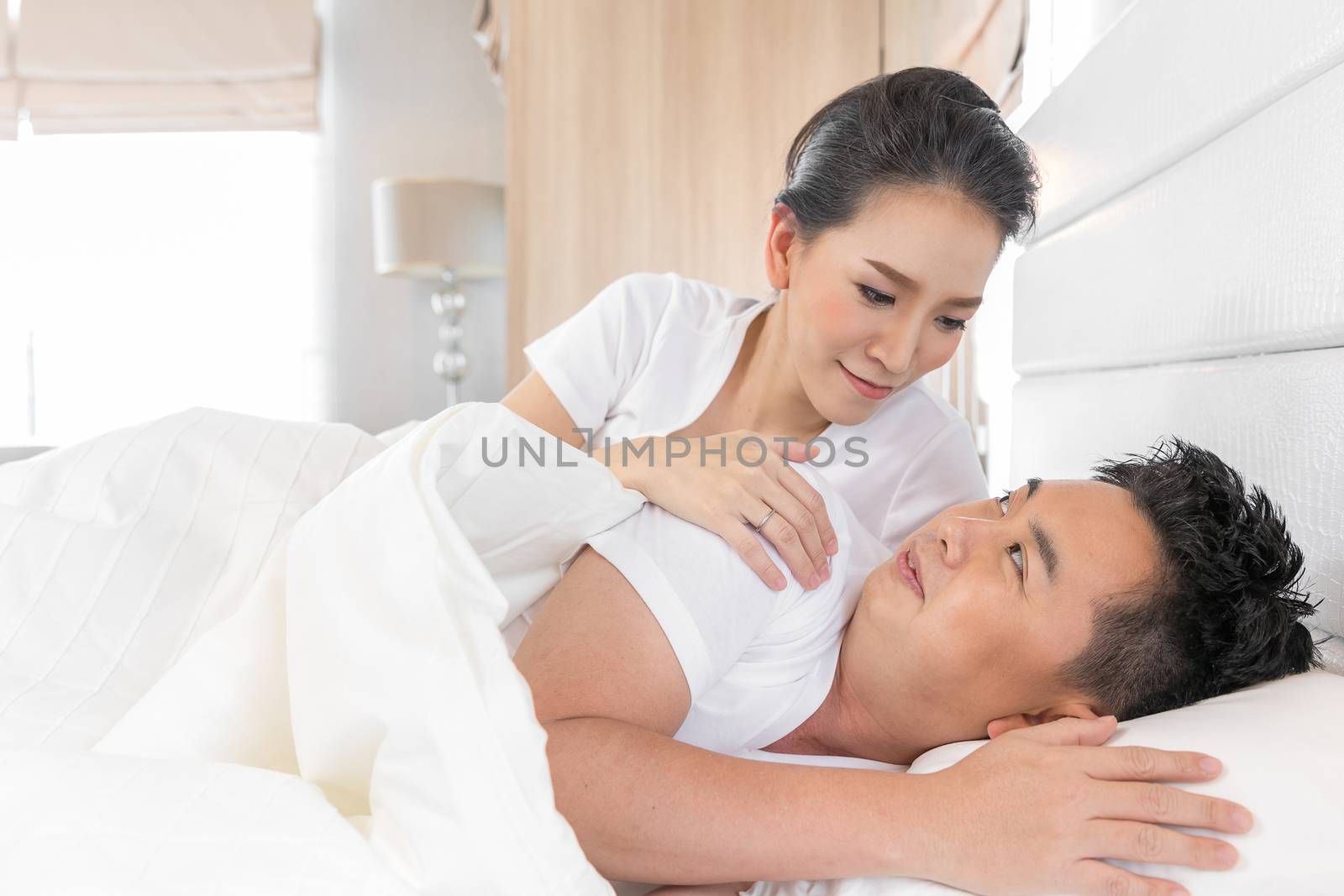 Young loving couple in the bed. Modern lifestyle concept