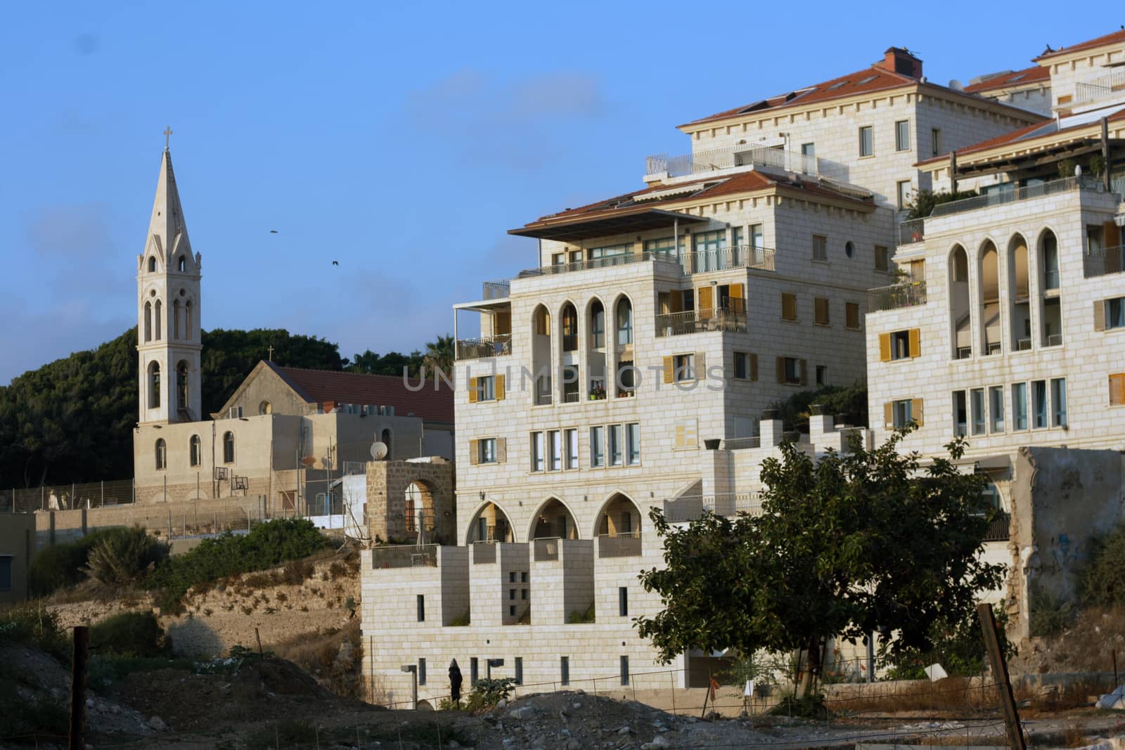Greek Orthodox church of St. George in Old Jaffa and new residential buildings area Tel Aviv-Yafo, Israel .