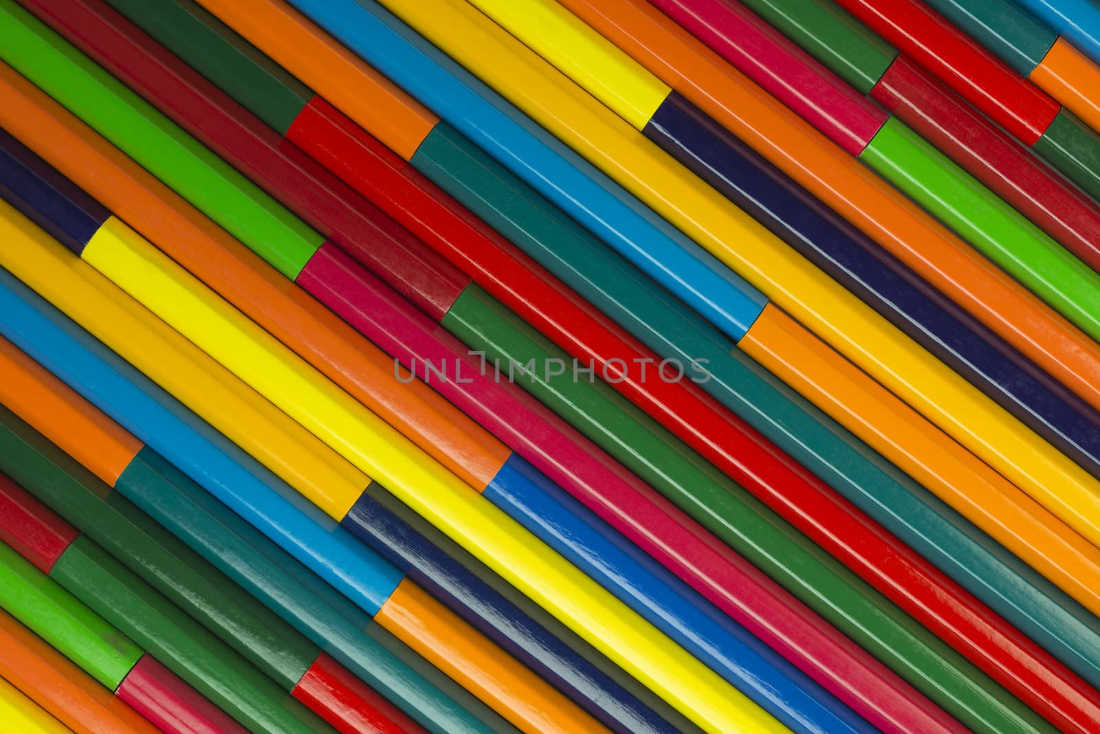 Collection of coloured pencils in a diagonal complementary colors set up as background picture

