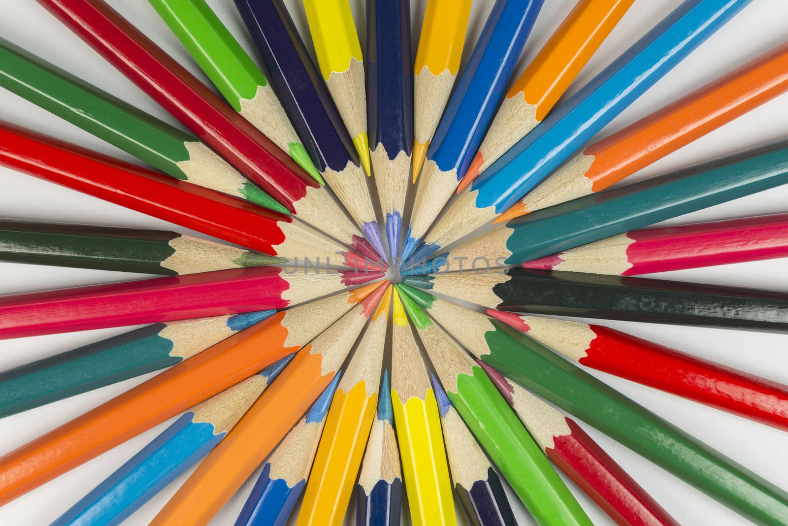 Abstract composition of complementary cirkel with color pencils against a white background
