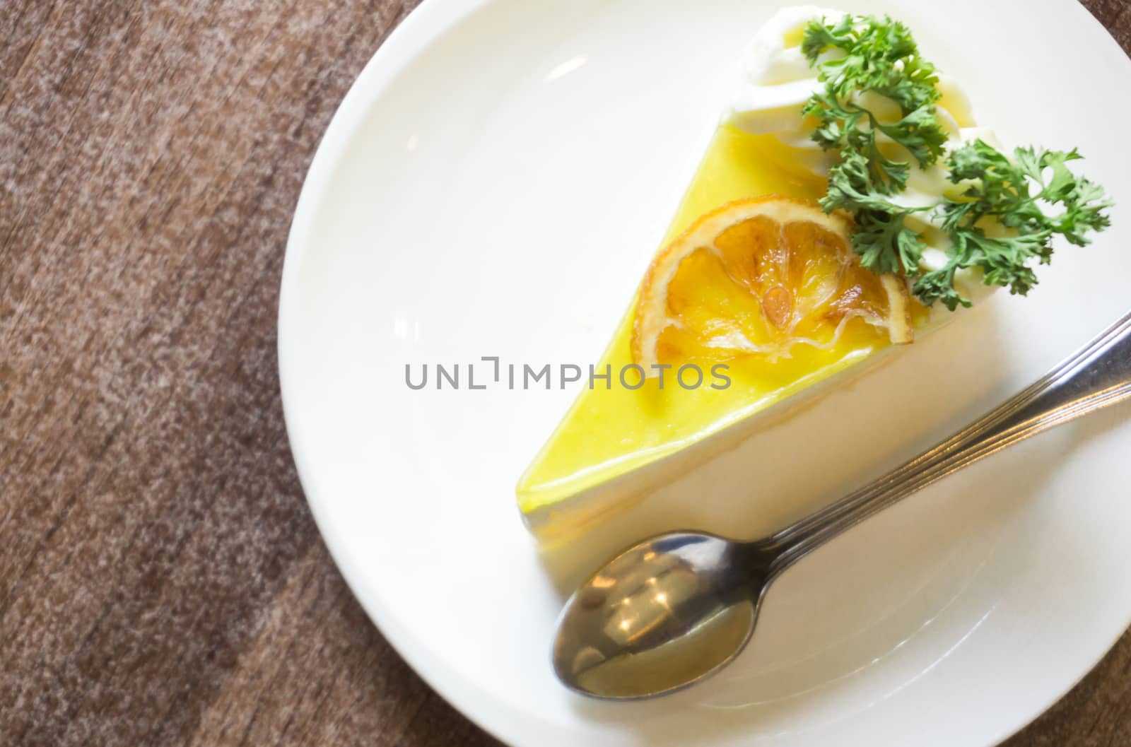 Closeup lemon cake on white plate in coffee shop for relax time concept