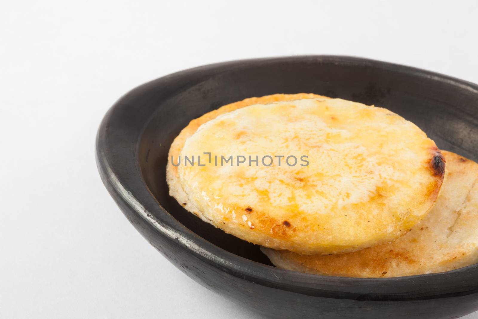 Traditional Colombian arepa topped with melted butter
