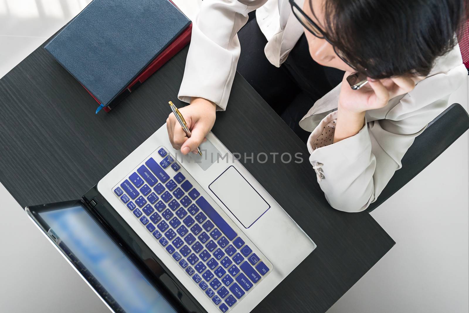 Young asian woman short hair in smart casual wear working on laptop in home office