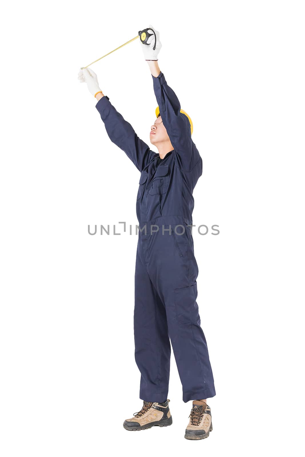 Young worker in unifrom with tape measure on white by stoonn