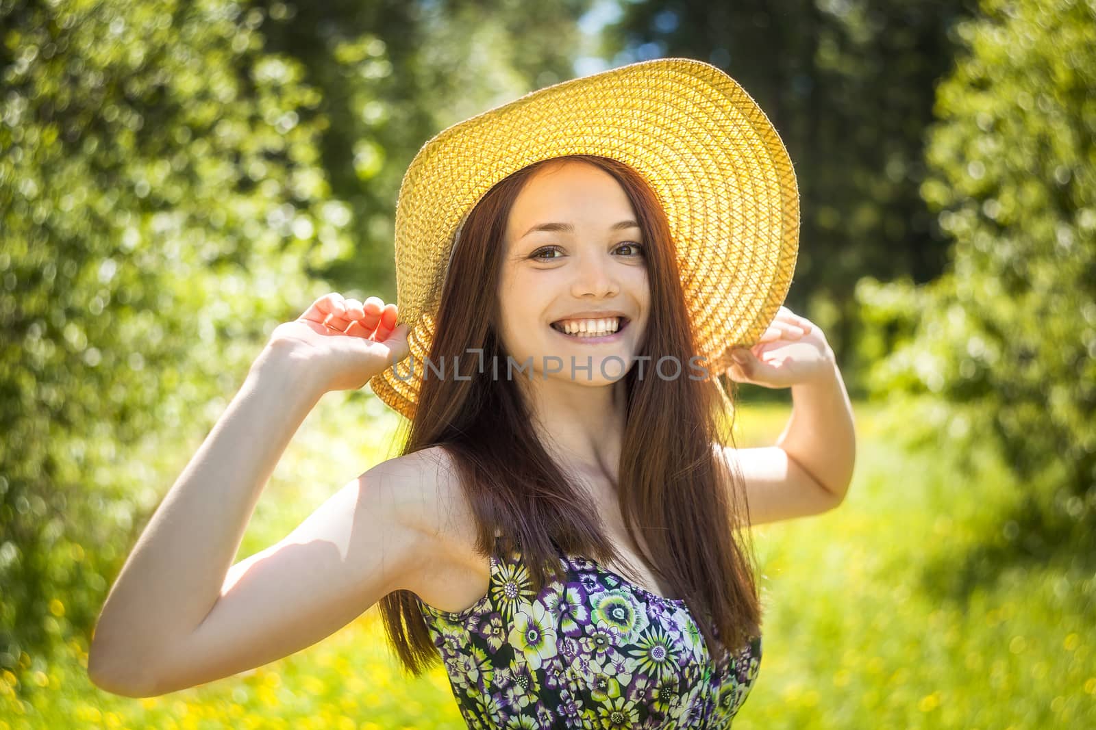 beautiful young brunette woman on the meadow by sveter