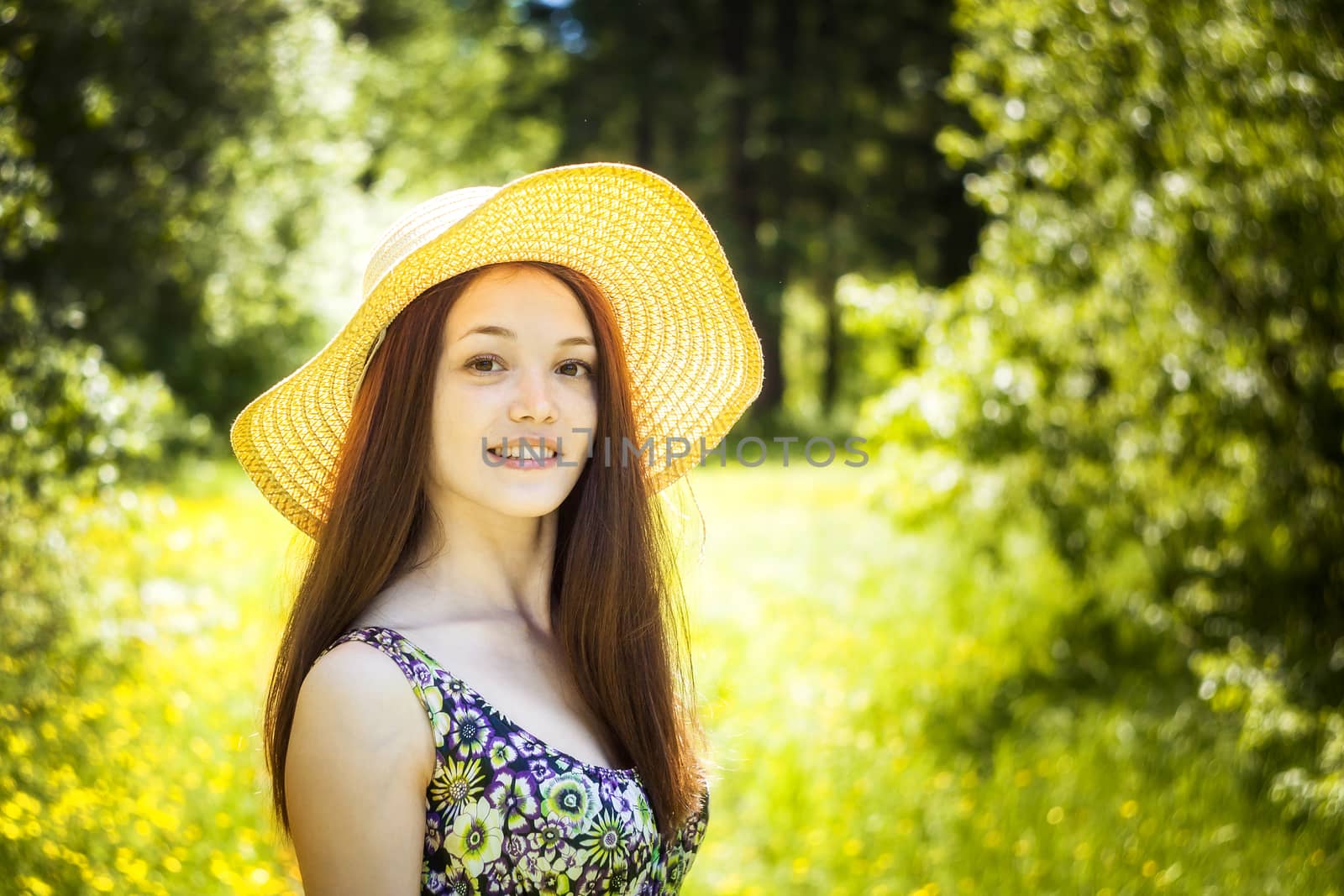 beautiful young brunette woman on the meadow on a warm summer day