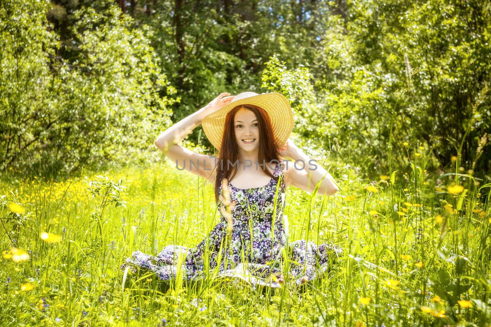 beautiful young brunette woman on the meadow by sveter