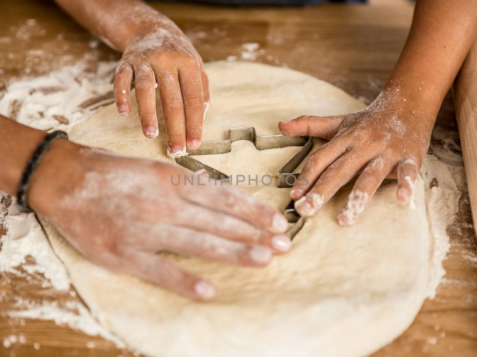 Close-up shot of hands on the paste learning to bake
