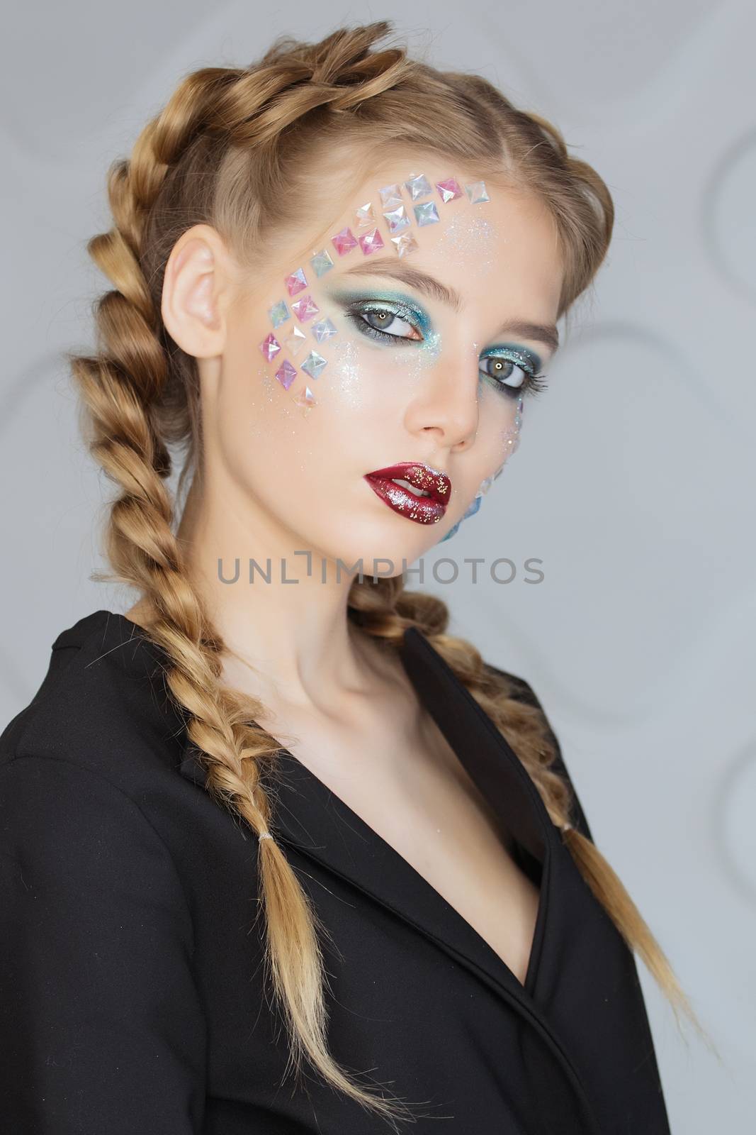 Fashion makeup. Woman with colorful makeup and body art.