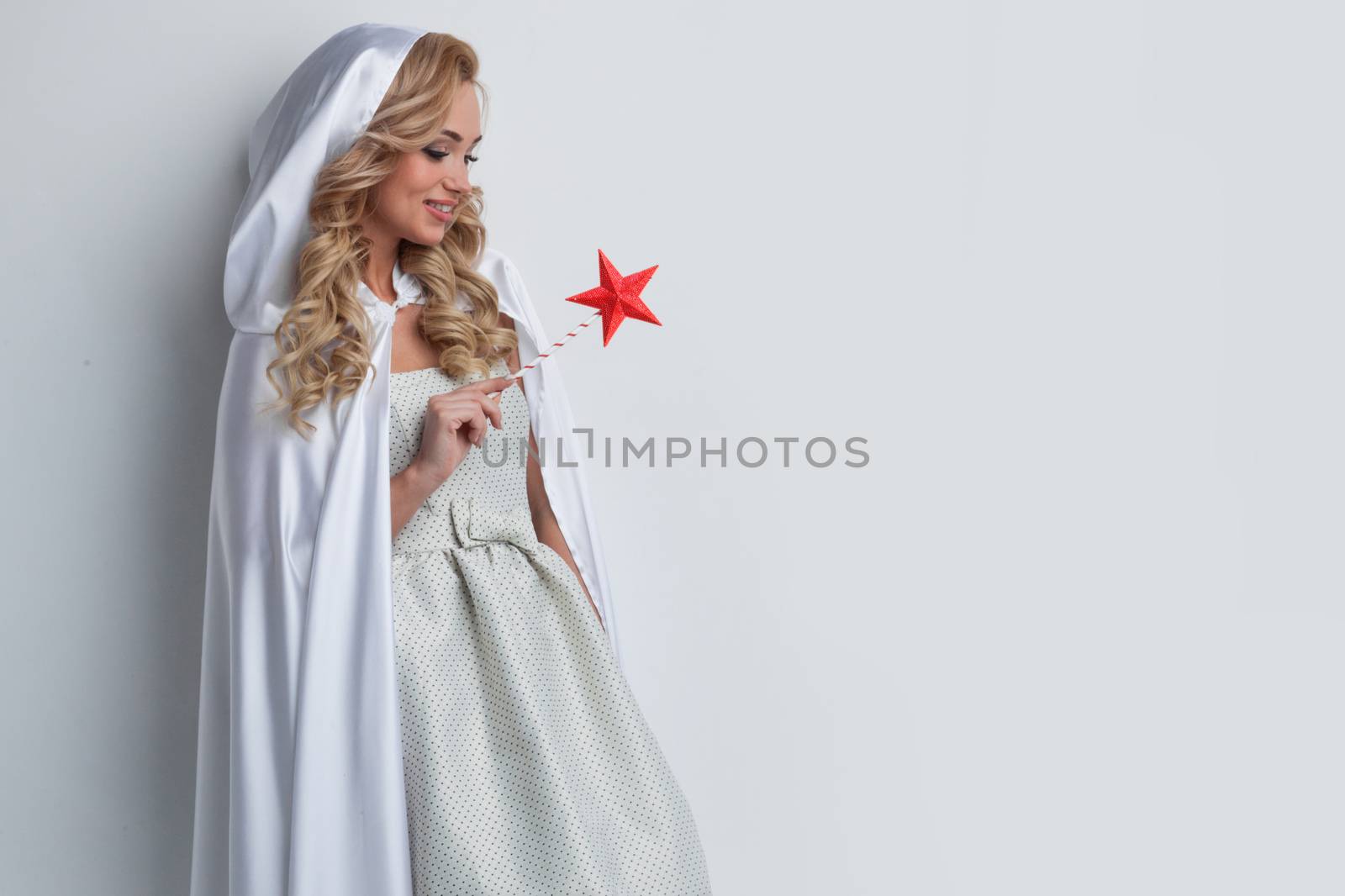 Portrait of beautiful fairy woman with star shaped magic wand