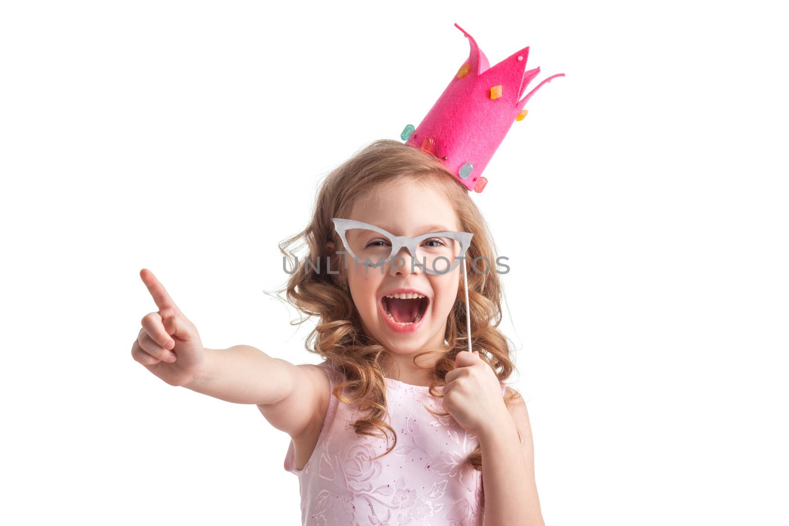 Funny princess girl in pink dress and crown holding party glasses on stick and saying something smart with finger up