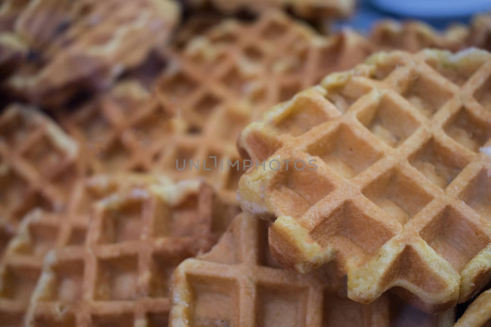 A group of waffles bacground disposed in a bakery