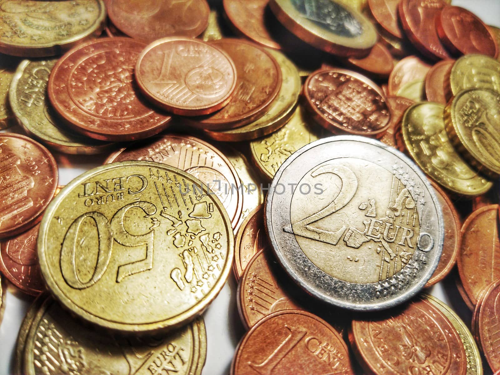 A group of euro coins disposed on a white background