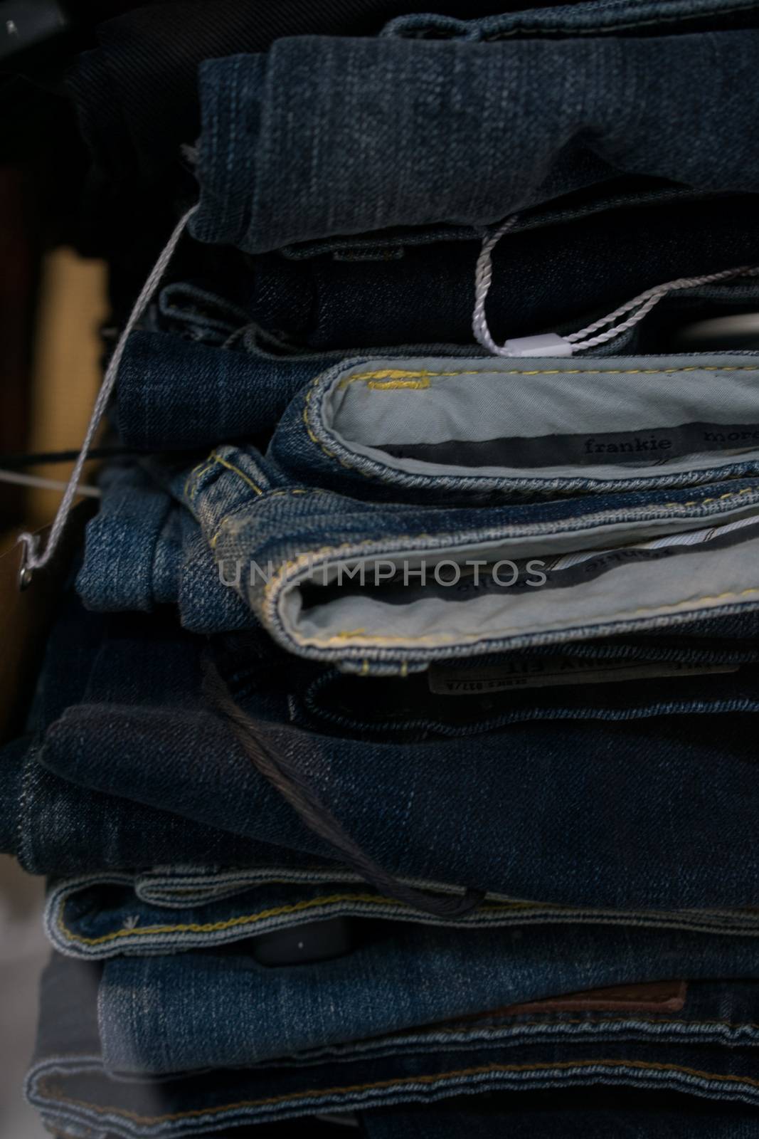 Pairs of jeans close up in a shop