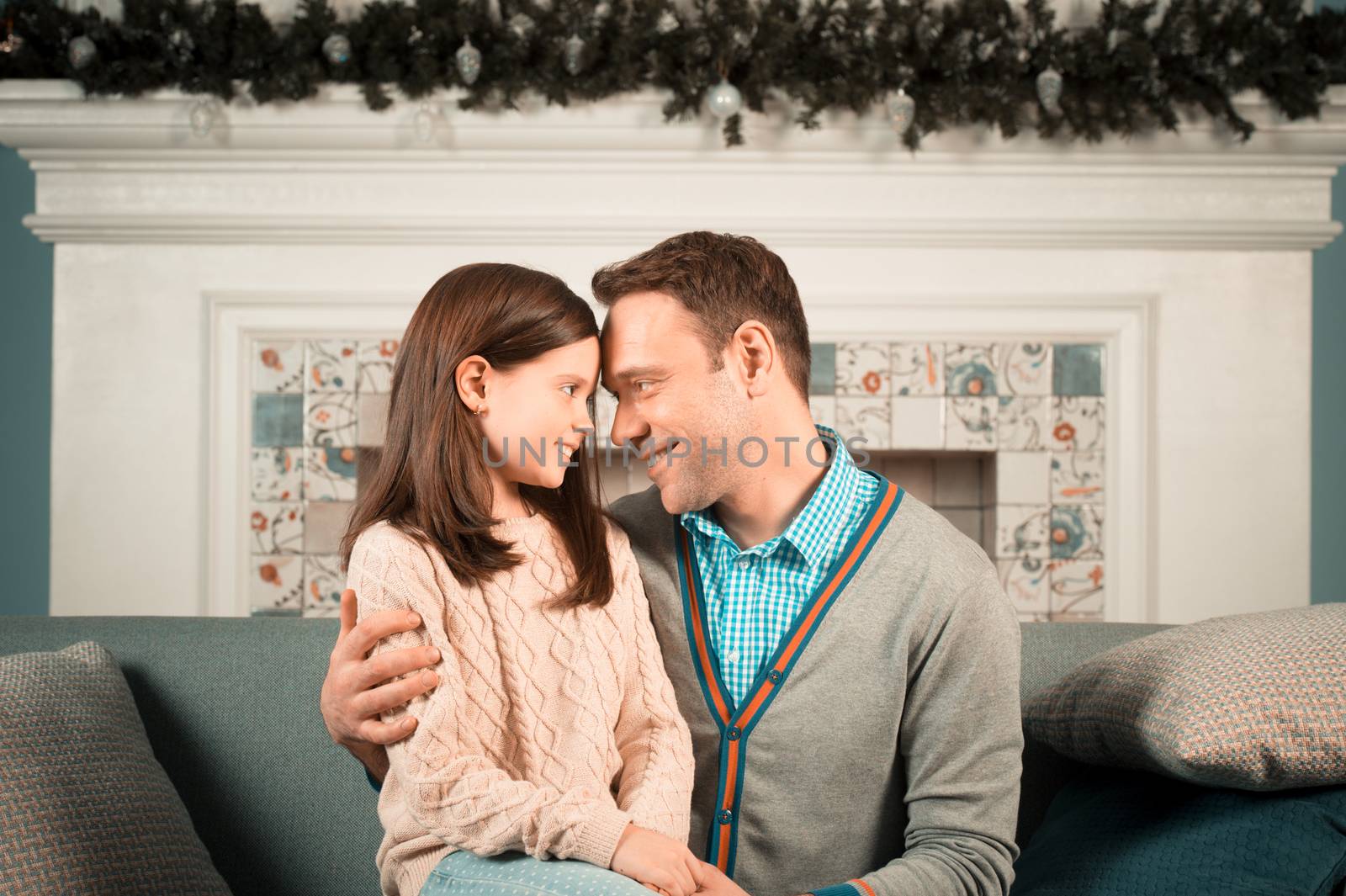 Family portrait of happy father and his daughter at home